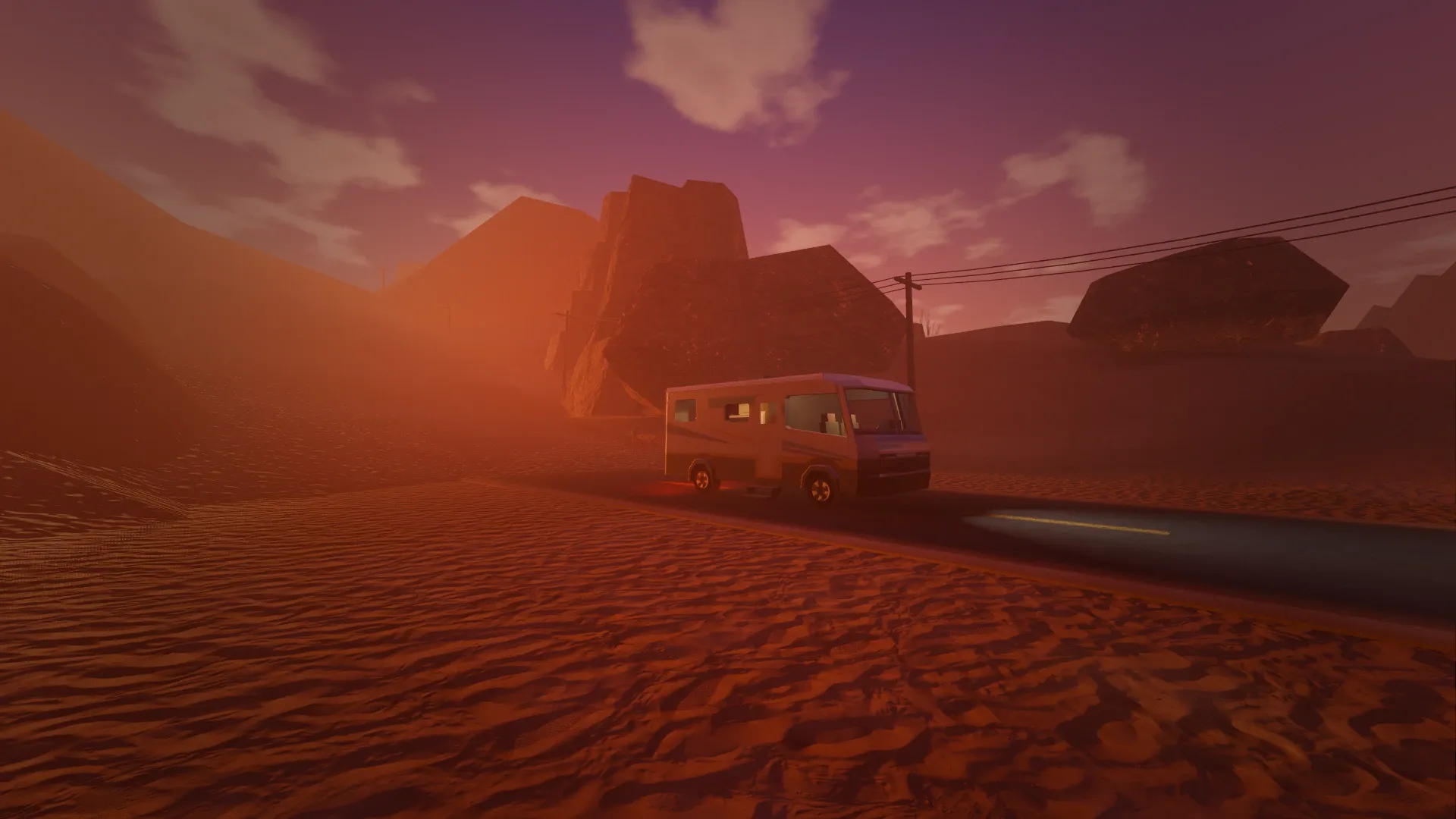 The camper parked on the highway beneath a towering mesa at sunset