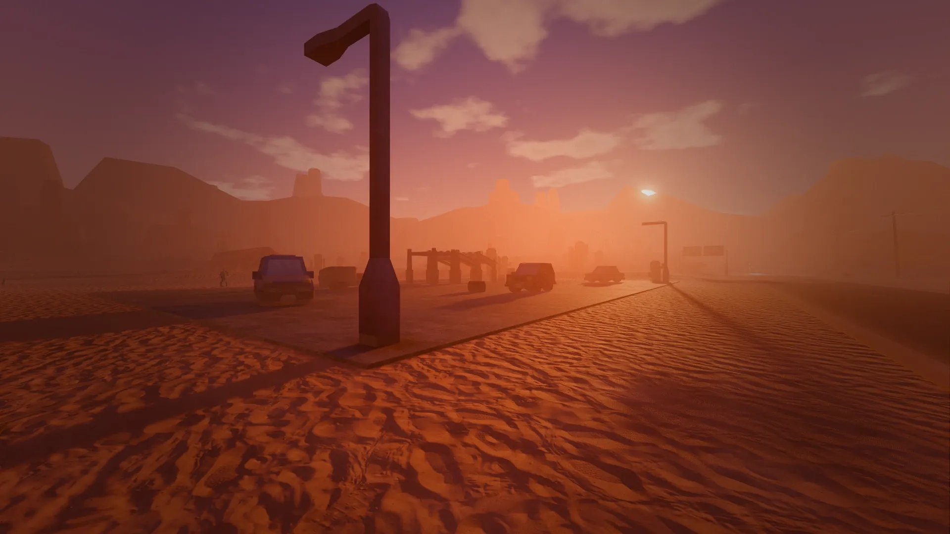 The desert rest stop lot with abandoned cars and streetlights at sunset